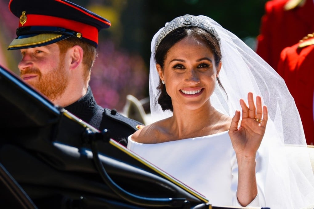 Meghan Markle waves to the crowd as she and Prince Harry go on the carriage procession after their wedding at Windsor Castle, west of London. Photo: Alamy