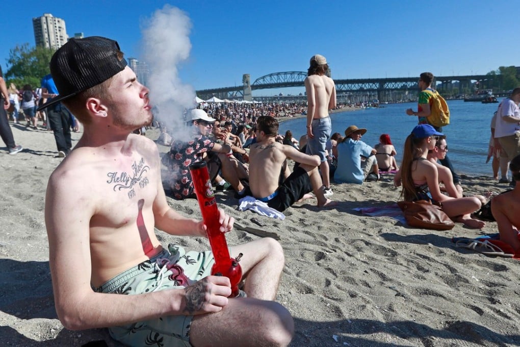 A man smokes a bong on a beach in Vancouver, Canada. Photo: AFP
