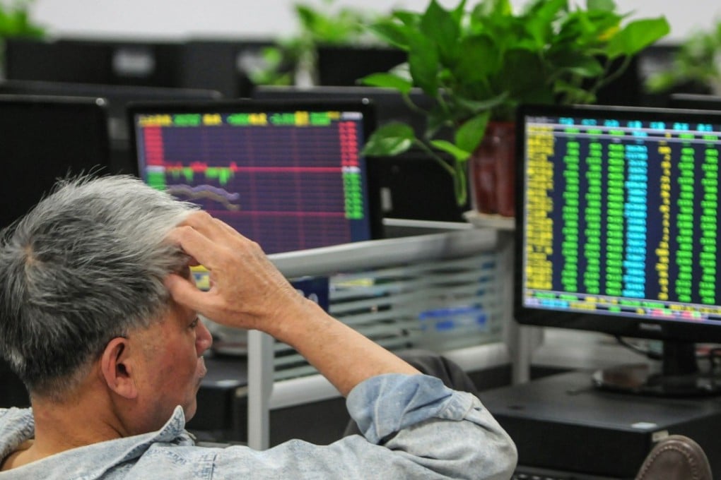 A investor monitors stock prices at a securities company in Jiujiang in China's central Jiangxi province. Chinese stock markets plunged to their lowest levels in almost four years on October Photo: AFP
