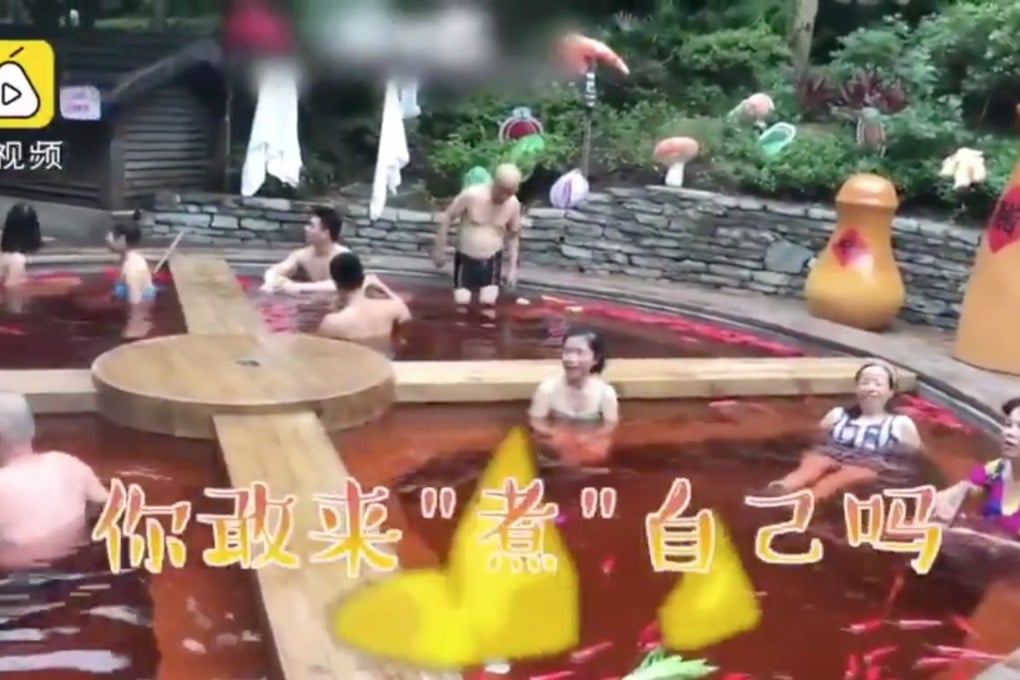 The novelty bathing area has bright red water, floating plastic “vegetables” and giant chopsticks to snap selfies with. Photo: Pear Video