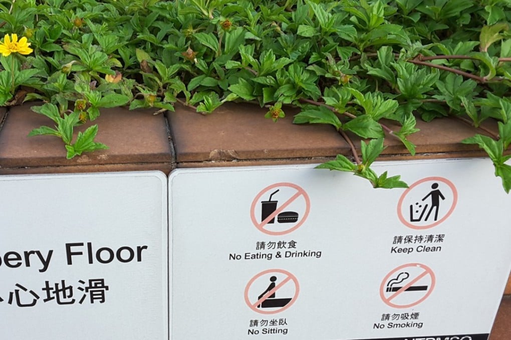 A sign banning sitting at a public space in the New Town Plaza mall in Sha Tin. Photo: SCMP / Shirley Zhao