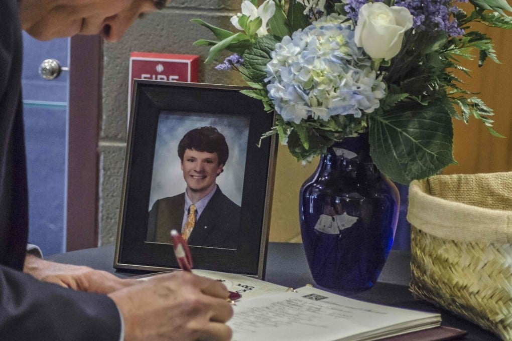 A mourner signs a guestbook during Otto Warmbier’s funeral. Picture: AFP