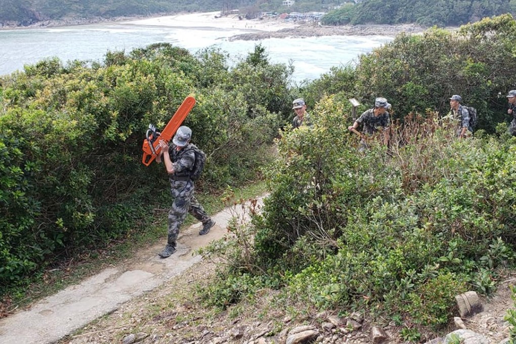 Soldiers from the PLA’s Hong Kong garrison help with the post-Typhoon Manghut clean-up on the MacLehose Trail on October 13.