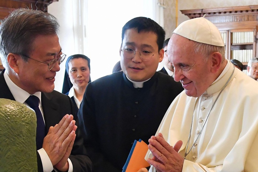 Pope Francis and South Korean President Moon Jae-in gesture as they exchange gifts at the Vatican on Thursday. Photo: Agence France-Presse
