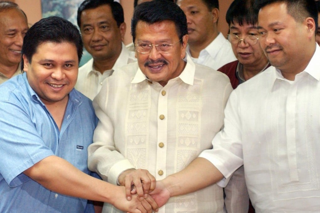 Jailed former president Joseph Estrada with his sons Jinggoy Estrada and JV Ejercito. Photo: AFP