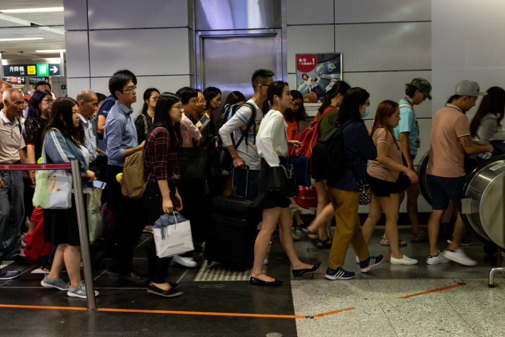 MTR commuters queue to ride an escalator inside Central station on October 16. Hong Kong census officials estimate that the city’s population would peak at 8.22 million in 2043 and thereafter start to decline. Photo: Bloomberg