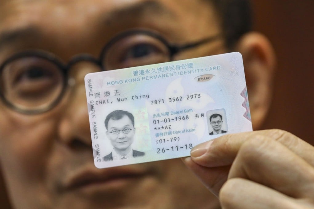 Chan Tin-chee, assistant director of the Immigration Department (personal documentation) holding the new smart Hong Kong identity card. Photo: Dickson Lee