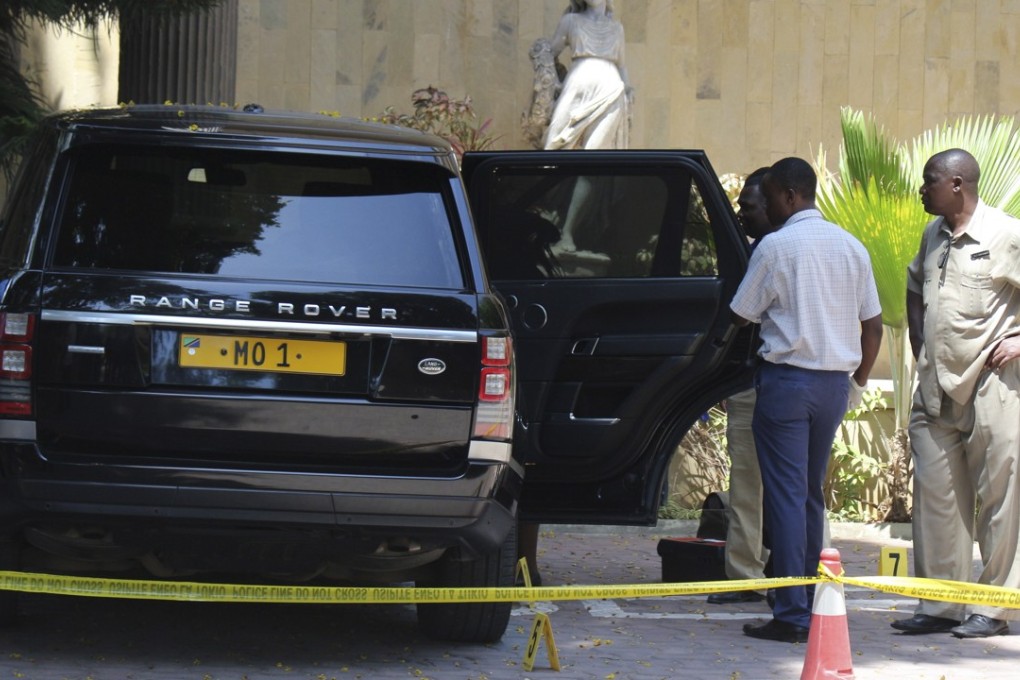 Tanzanian police officers inspect a vehicle with registration number ‘MO 1’ that belongs to Mohammed Dewji. Photo: EPA