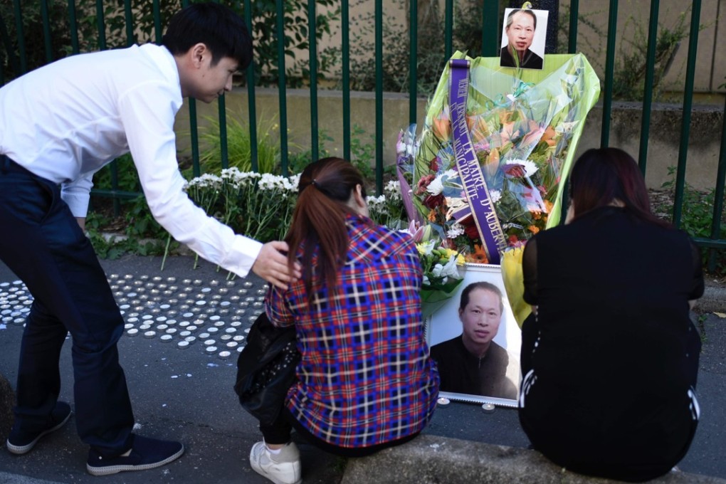 A member of the Chinese community comforts the sister (centre) and widow (right) of Zhang Chaolin, who died after a brutal mugging that put him in a coma. Photo: AFP