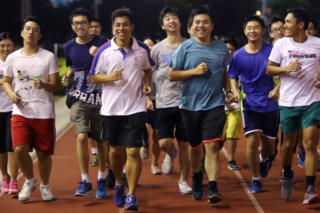 The running training programme, led by coach Terry Chung (fourth left) is provided by Tung Wah Group of Hospitals. Photo: Edward Wong