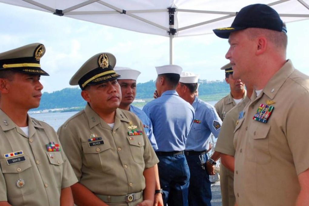 Former Navy commander Troy Amundson (far right) speaking with members of the Philippine navy in Subic Bay in 2010. Photo: US Navy