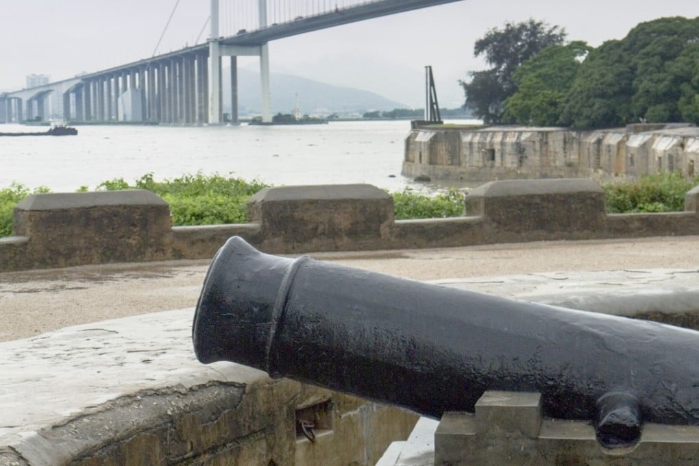 A cannon at the Weiyuan Fort trained on the Pearl River with the Humen bridge in the background. Photo: Stuart Heaver