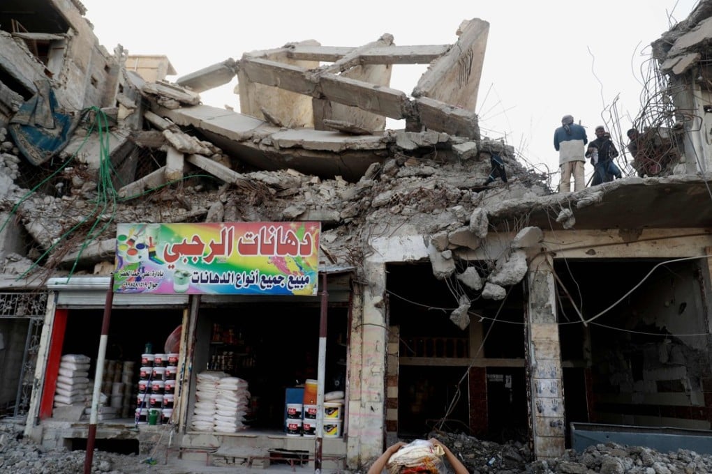 Labourers clear debris from a destroyed building in the Syrian city of Raqa. Photo: AFP