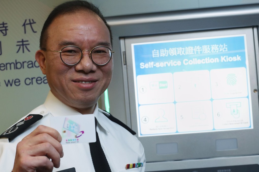 Immigration Department deputy director Erick Tsang Kwok-wai with an early version of the next smart ID card to be issued in Hong Kong this December. Photo: Winson Wong