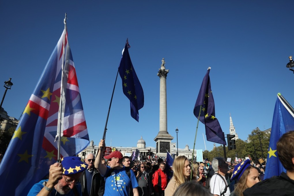 Demonstrators hold European Union flags and Union Jacks, in front on Nelson's Column on Trafalgar Square during the anti-Brexit People's Vote march in London, UK, on Saturday. Photo: Bloomberg