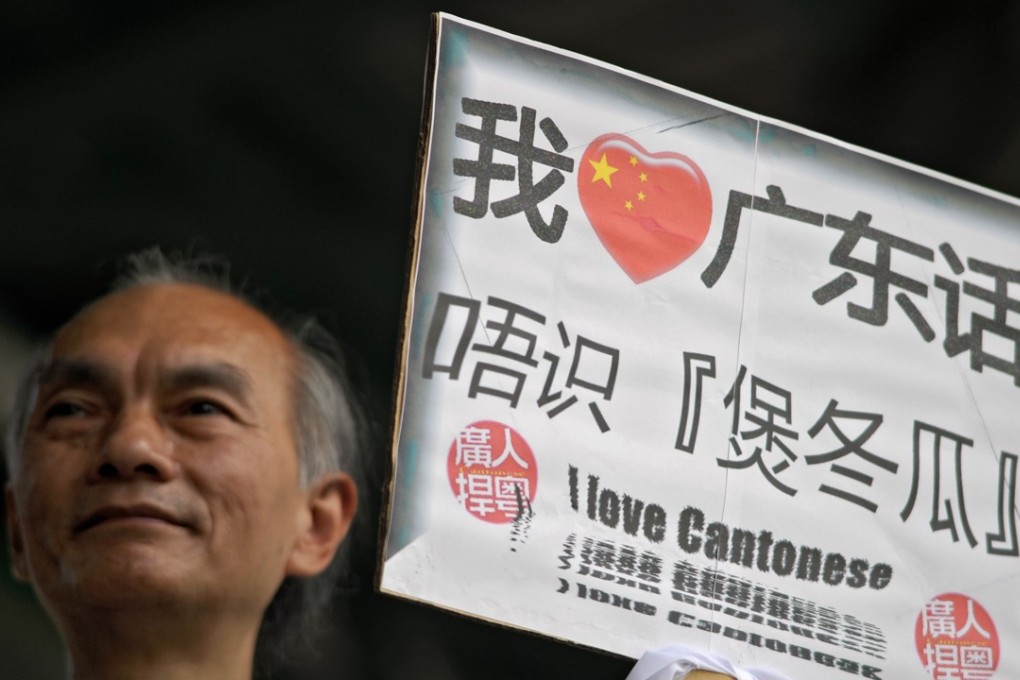 A man holds a sign professing his love for Cantonese, the main language used in Hong Kong. Photo: Anthony Dickson