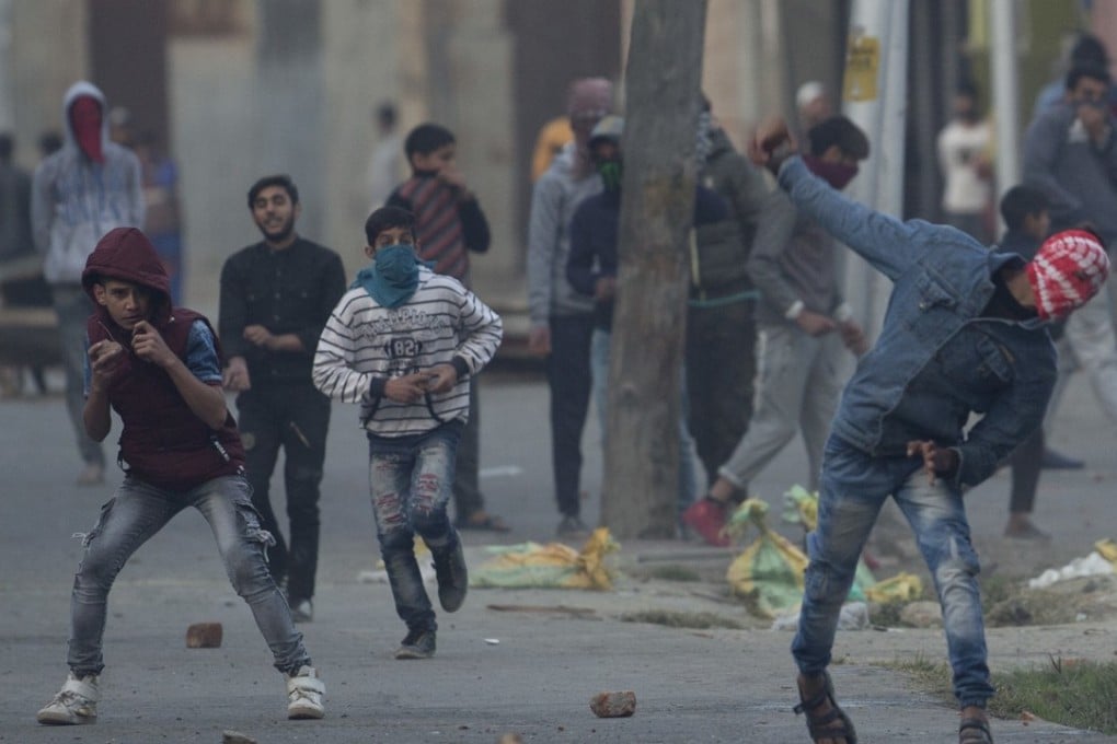 Protesters throw rocks and bricks at Indian security forces in Srinagar, Indian-controlled Kashmir, on Friday. Photo: EPA