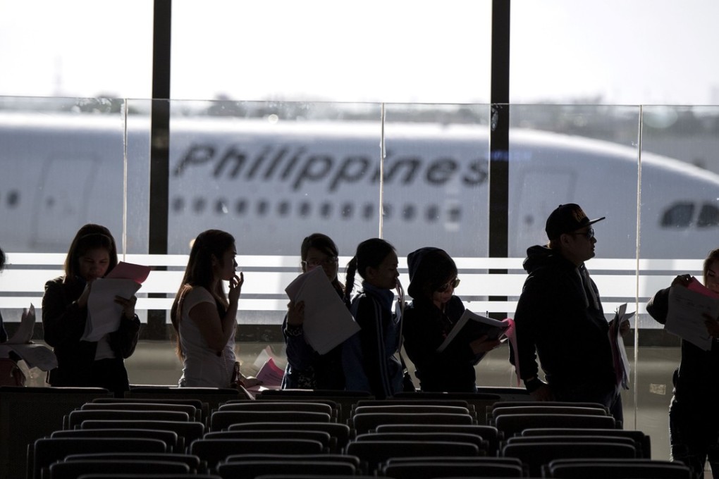Filipino workers returning home from Kuwait arriving at Manila International Airport. Photo: AFP