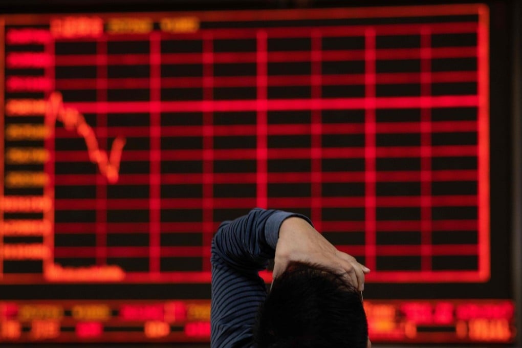 An investor looks at stock price movements on a screen at a securities company in Beijing on October 12. Despite the sharp falls in asset prices in China over the past several months, investors continue to differentiate between the current sell-offs and previous crisis in 2015-16. Photo: AFP