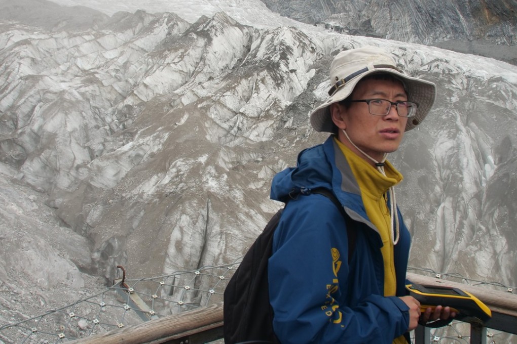 Geologist Chen Yanjun overlooks Baishui Glacier No 1 on the Jade Dragon Snow Mountain in Yunnan, China. Scientists say this glacier is one of the fastest-melting in the world due to climate change, having lost 60 per cent of its mass and shrunk 250 meters since 1982. Photo: AP