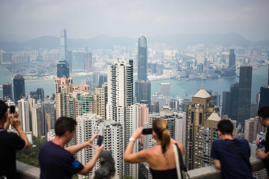Tourists take photos on Victoria Peak, Hong Kong. Investors and property groups in Hong Kong, Singapore, mainland China and the Gulf have been moving quickly in recent months to stimulate the local proptech ecosystems. Photo: AFP