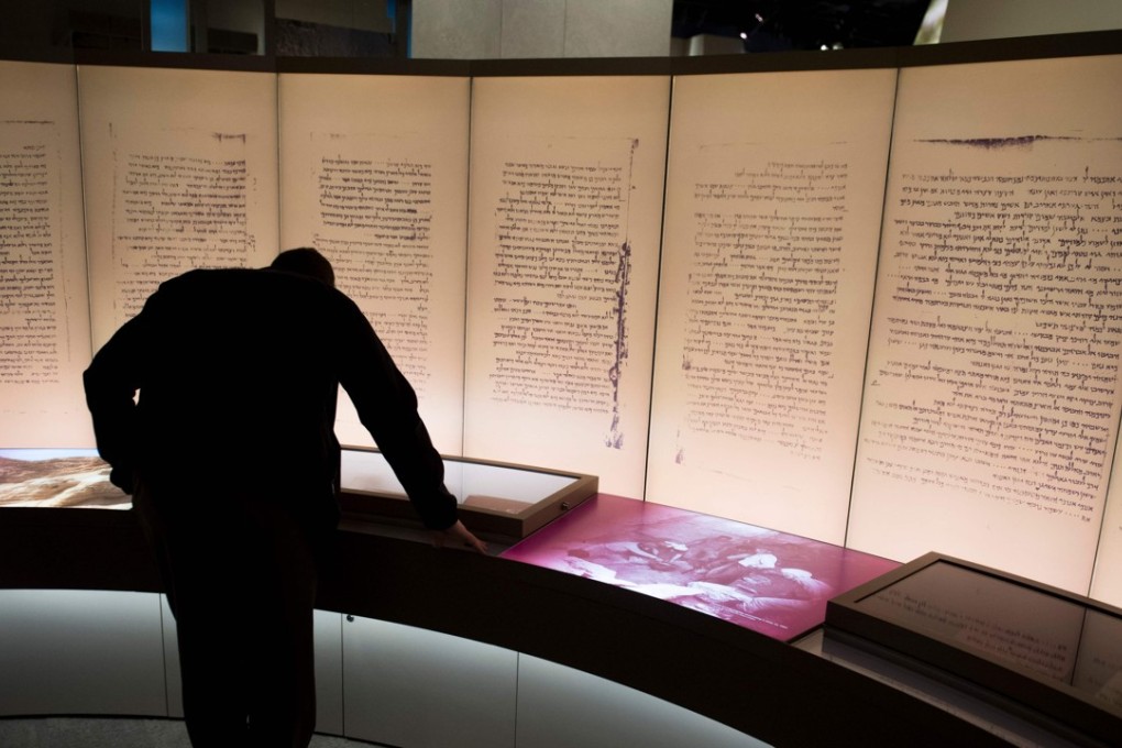 Visitors look at an exhibit about the Dead Sea scrolls at the Museum of the Bible. Photo: AFP