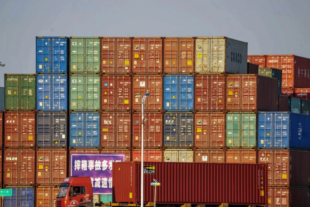 A truck transports a container next to stacked containers at a port in Qingdao in China's eastern Shandong province on October 12, 2018. Photo: STR/AFP