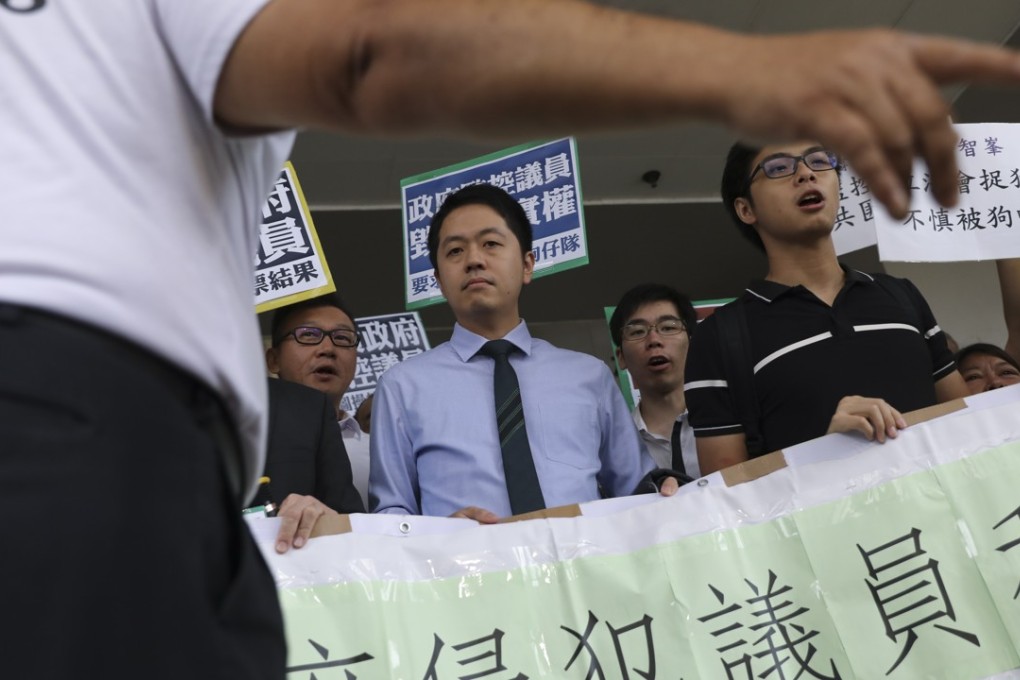 Lawmaker Ted Hui (centre) makes his first court appearance over charges relating to the phone-snatching incident. Photo: Sam Tsang