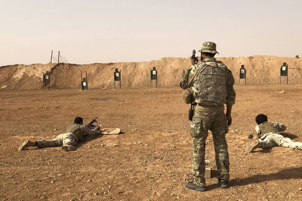 Members of the Maghawir al-Thawra Syrian opposition group receive firearms training from US Army Special Forces soldiers. Photo: AP