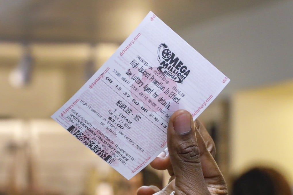 A customer holing up their Mega Millions lottery ticket at a shop in Washington on October 23, 2018. Photo: EPA