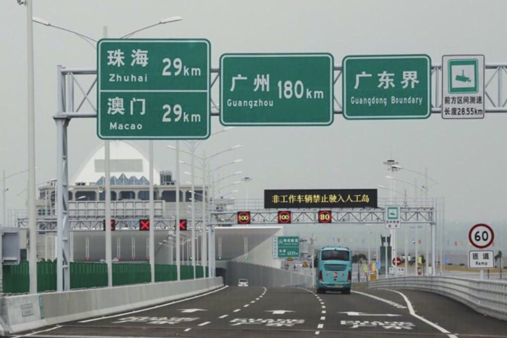 The first cars and buses crossing the Hong Kong-Zhuhai-Macau Bridge enter the tunnel on the eastern artificial island. Photo: K.Y. Cheng