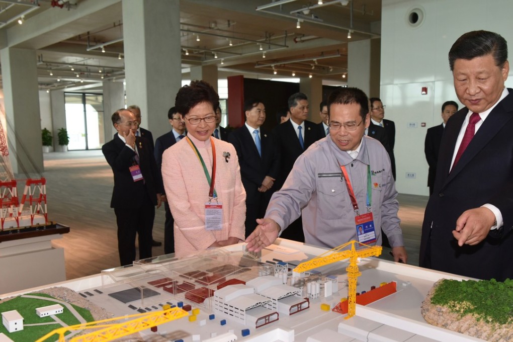 Chinese President Xi Jinping (right) and Hong Kong Chief Executive Carrie Lam (left) view a model of the Hong Kong-Zhuhai-Macau Bridge in Zhuhai in south China’s Guangdong province on Tuesday. Photo: AP