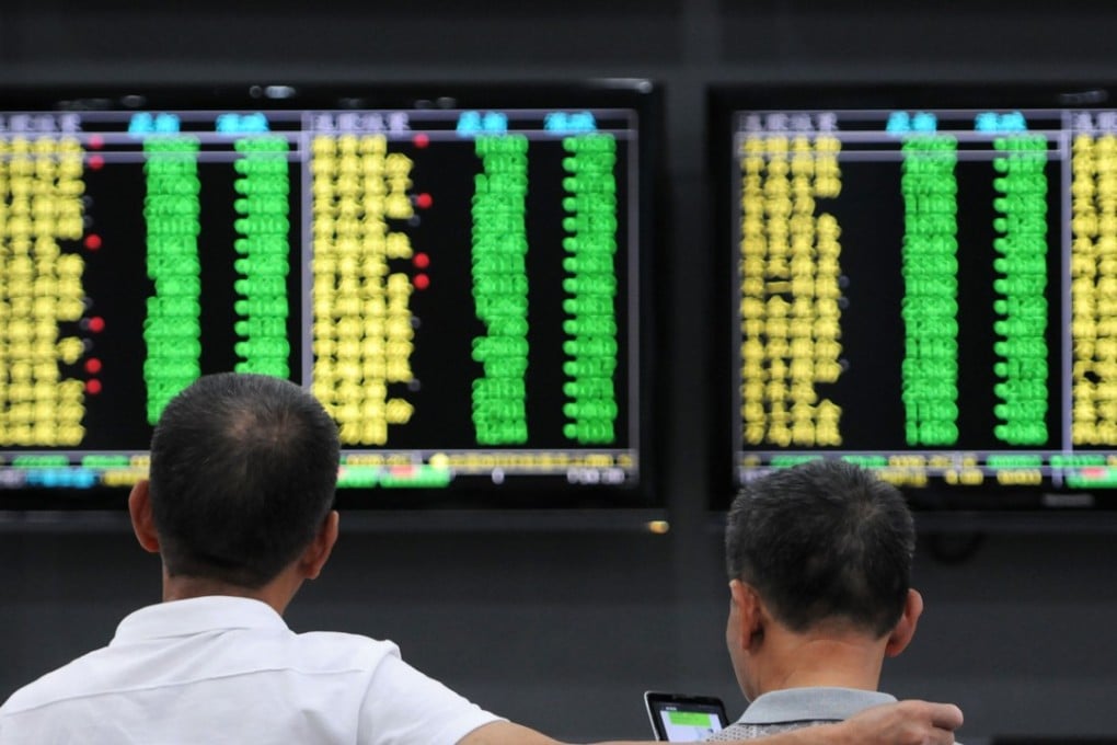 Investors monitor stock prices at a securities company in Jiujiang in China's central Jiangxi province. The benchmark Shanghai Composite Index rose by 0.3 per cent on Wednesday, paring a gain of as much as 1.8 per cent. Photo: AFP