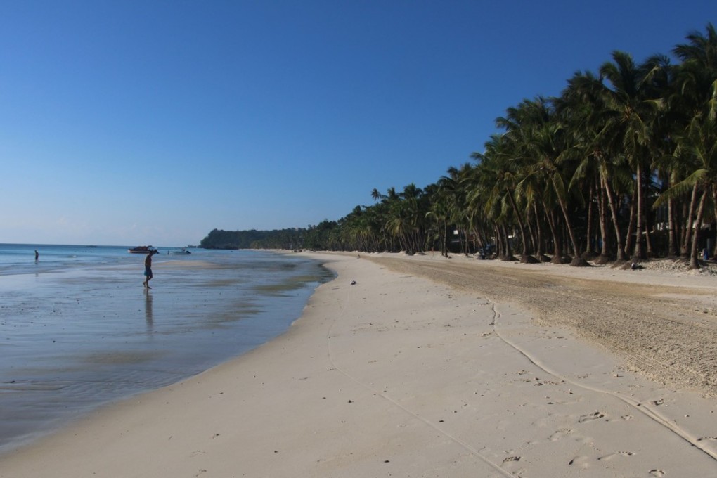 Residents walk along a beach on the Philippine island of Boracay. Photo: AFP