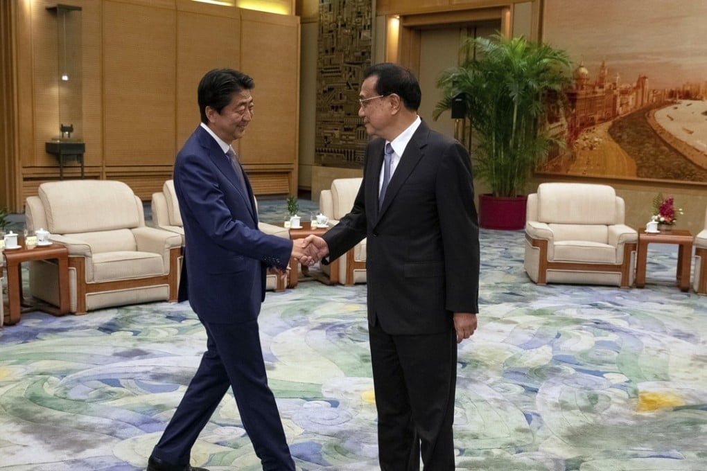 Chinese Premier Li Keqiang (right) greets Japanese Prime Minister Shinzo Abe at the Great Hall of the People in Beijing on Thursday. Photo: AP