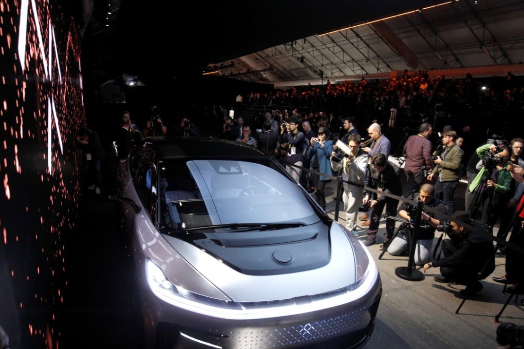 Journalists gather around a Faraday Future FF 91 electric car during an unveiling event at CES in Las Vegas, Nevada on January 3, 2017. Photo: Reuters