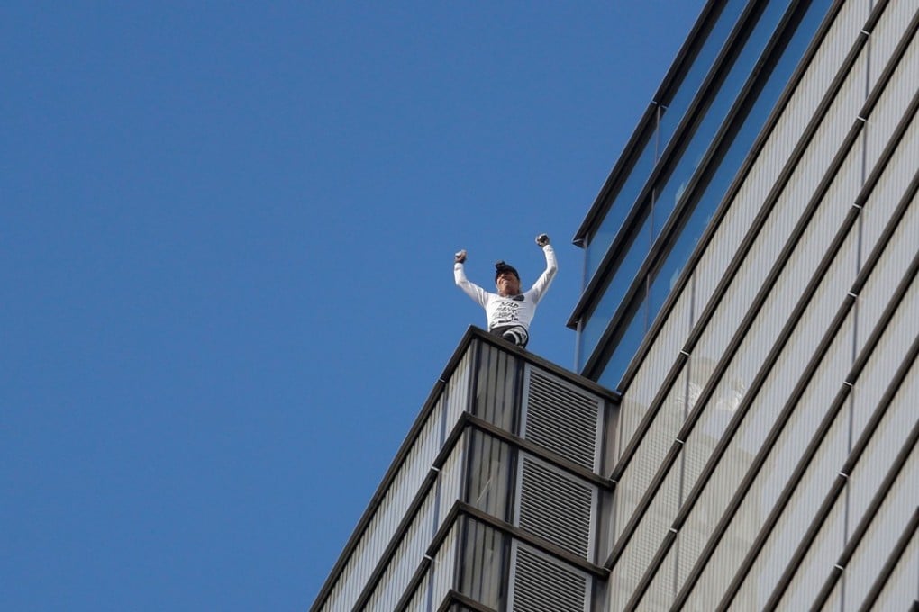French freeclimber Alain Robert celebrates as he completes his climb of Heron Tower in London’s financial district on October 25, 2018. Photo: Reuters