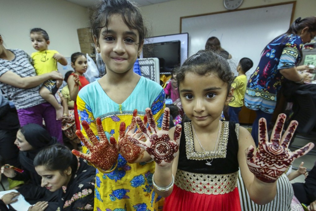 Two Muslim children show off henna art as part of the community’s celebration of the end of Ramadan in June. The Hong Kong government hopes its new measures can bridge the gaps in the current ethnic minority support network. Photo: Edmond So