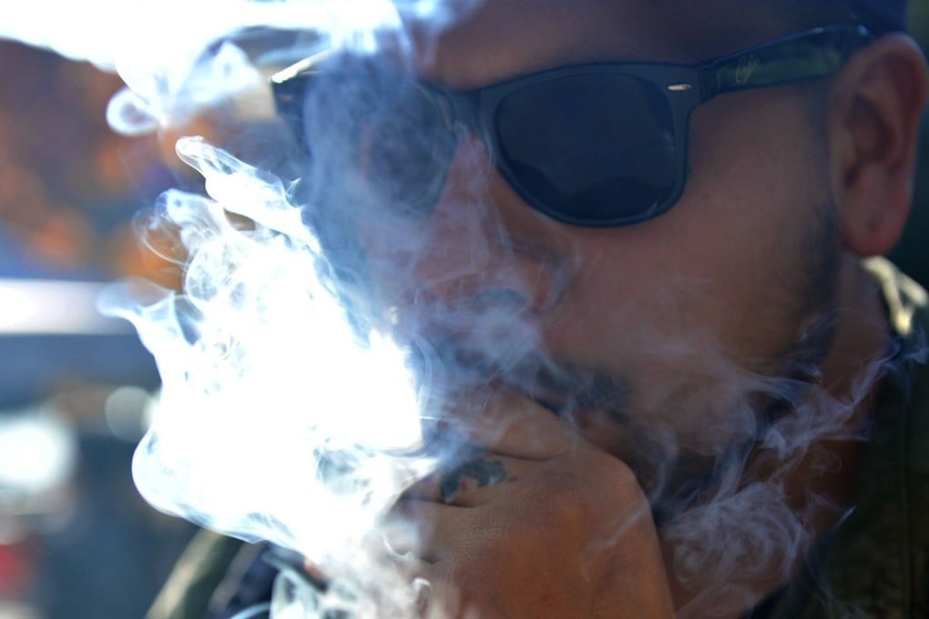 Smoking marijuana in Vancouver on October 17. Statistics Canada says 5.4 million Canadians will buy cannabis from legal dispensaries in 2018. Photo: AFP
