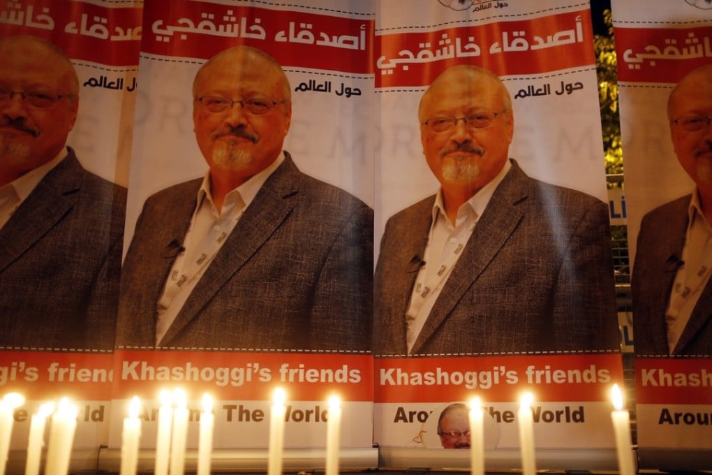 Candles shine on placards protesting the killing of Saudi journalist Jamal Khashoggi during a vigil outside Saudi Arabia's consulate in Istanbul on Thursday. Photo: AP