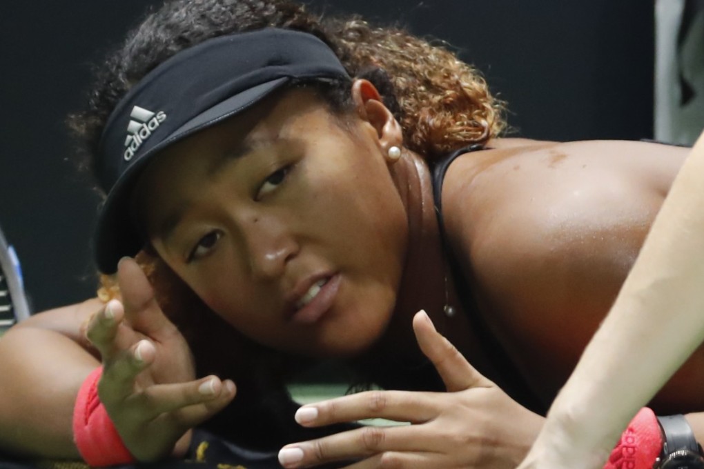 Naomi Osaka receives treatment on the court during a medical timeout against Kiki Bertens at the WTA Finals in Singapore. Photo: AP