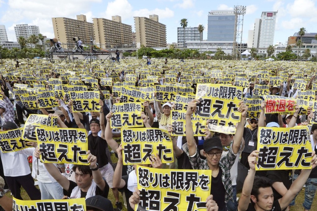 Protesters hold placards that read: “Our anger has reached its limit.” Photo: AP