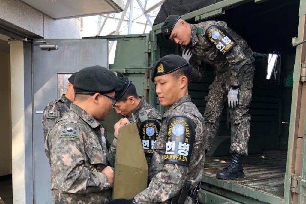 South Korean soldiers carry military equipment before leaving the Joint Security Area on Thursday. Photo: EPA