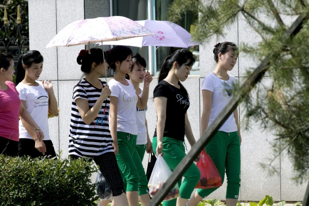North Korean workers walk into the Hong Chao Zhi Yi garment factory in Hunchun in this 2017 photo. Photo: AP