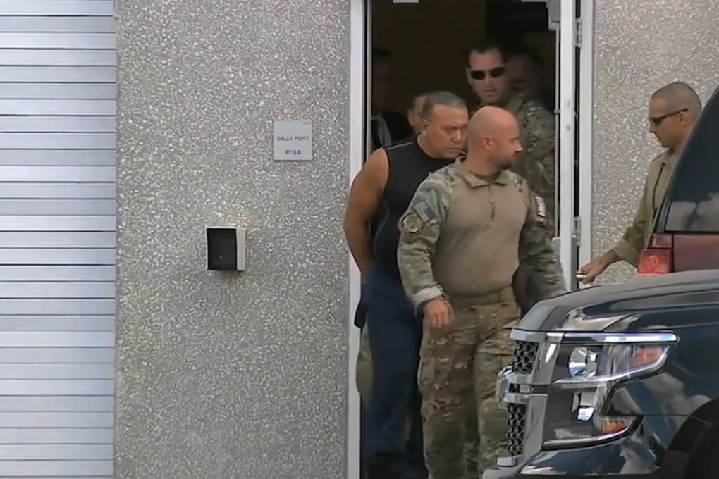This frame grab from video provided by WPLG-TV shows FBI agents escorting mail bomb suspect Cesar Sayoc, in sleeveless shirt, in Miramar, Florida, on Friday. Photo: WPLG/AP