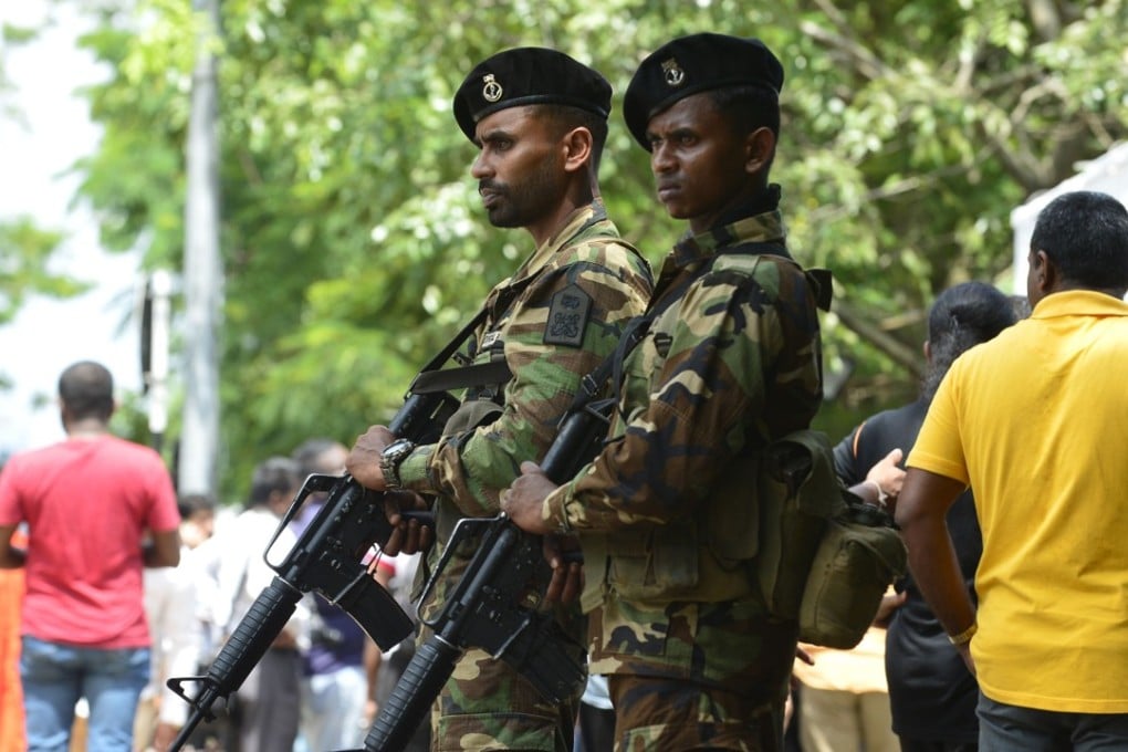 Sri Lankan soldiers stand guard at Mahinda Rajapakse's residence after he was sworn in as prime minister in Colombo. Photo: AFP