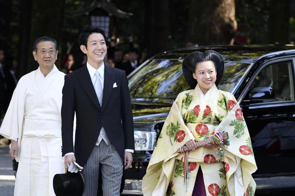 Japanese Princess Ayako, the third daughter of the late Prince Takamado, dressed in traditional ceremonial gown, and Japanese businessman Kei Moriya arrive at Meiji Shrine for their wedding. Photo: Kyodo