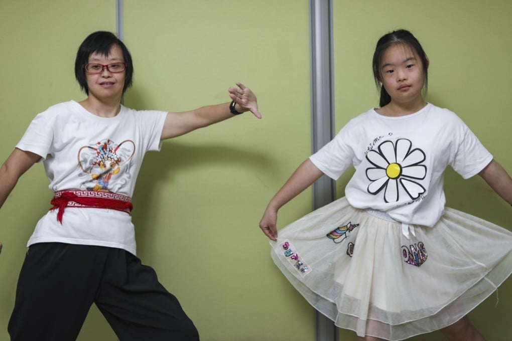 Gigi Chan (left), 40, and Bonnie So, 14, both work hard on their dreams despite their Down’s syndrome. They are two of 12 people photographed for the exhibition ‘With a Little Something Extra’ at the University of Hong Kong. Photo: Xiaomei Chen