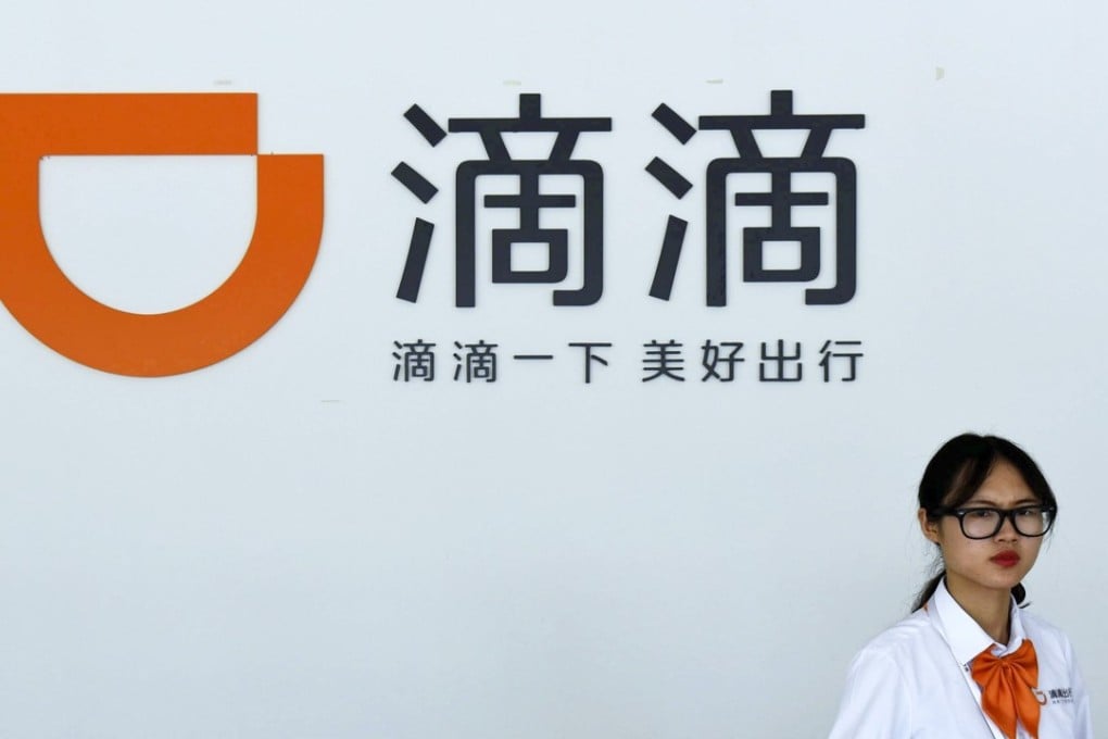 A receptionist walks by front desk of the service station for Didi Chuxing's drivers in Hangzhou in east China's Zhejiang province. Photo: AP