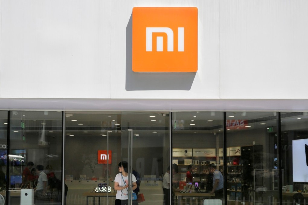 A customer walks out of a Xiaomi store in Beijing. Photo: Reuters